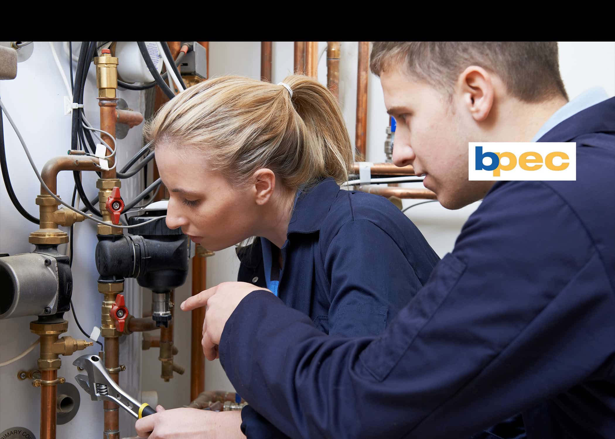 Two people working on pipes