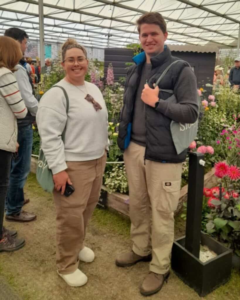 Two students smiling at the camera at the Chelsea Flower Show